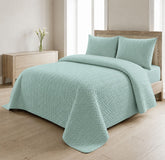 Mint green quilted 3-piece bed spread set with two matching pillow shams on a made bed