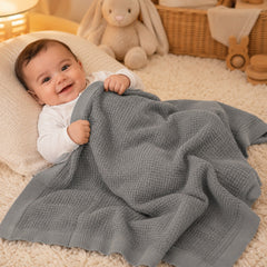 Baby wrapped in grey waffle cotton thermal blanket