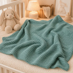 Teal waffle baby thermal blanket draped in a nursery