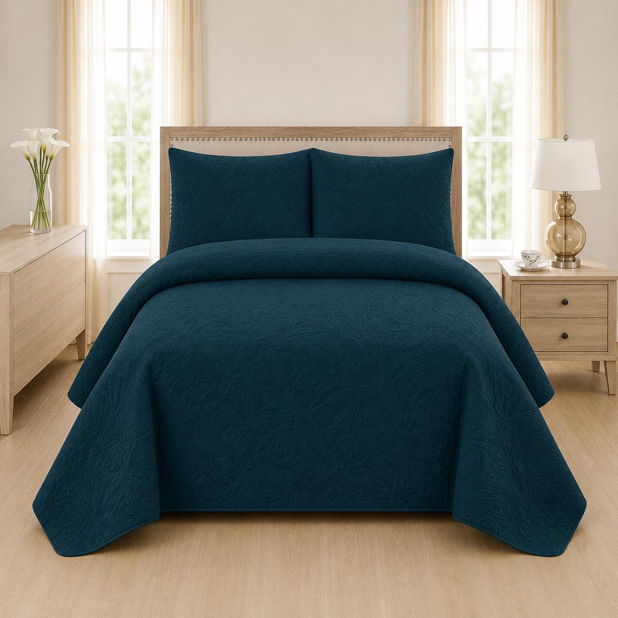 Teal blue quilted bedspread styled on a bed in a cosy neutral bedroom