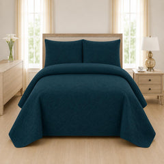 Teal blue quilted bedspread styled on a bed in a cosy neutral bedroom