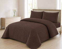 Brown quilted bedspread styled on a bed in a cosy neutral bedroom
