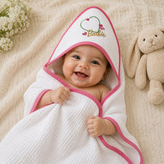 Baby lying in the Barbie heart hooded baby towel