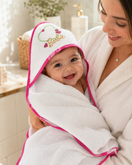 Mother holding baby in the Barbie heart hooded towel in the bathroom