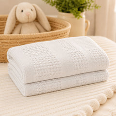 White basketweave cotton cellular baby blanket folded