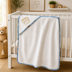 Prince crown hooded baby towel hanging on a white crib