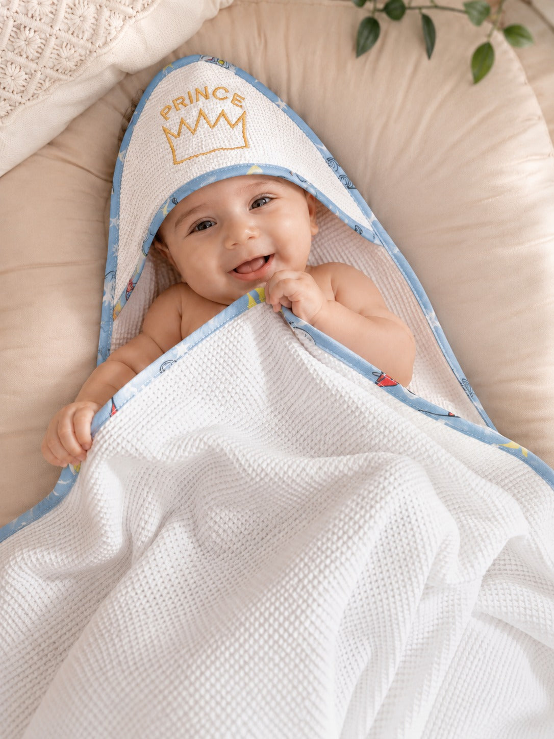 Baby wrapped in the Prince crown hooded baby towel